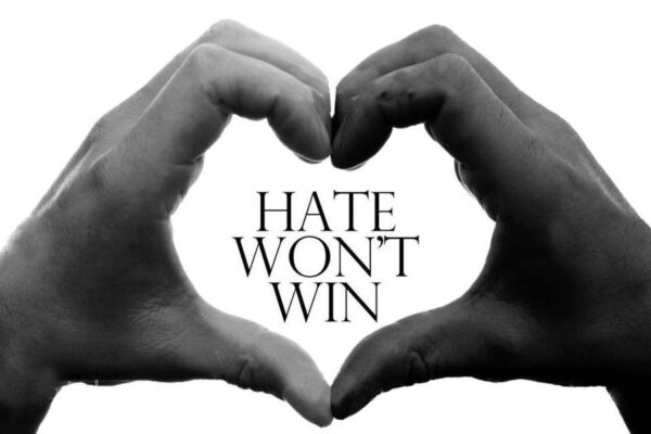 Text: Hate Won't Win with white hand & black hand forming a hard around the words