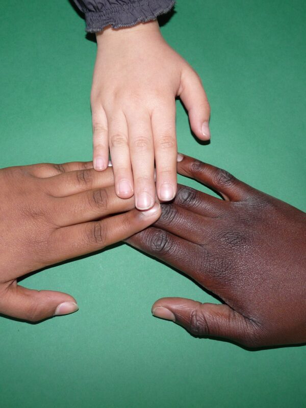 Multi-cultural races hands coming together