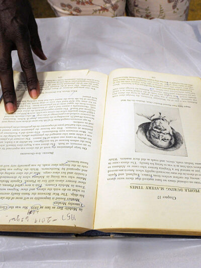 A display on slavery with a whip, book, and shackles