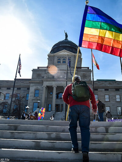 Demonstrators gather on the steps of the Montana State Capitol protesting anti-LGBTQ+ legislation.