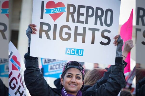 woman holding a sign reading I heart repro rights