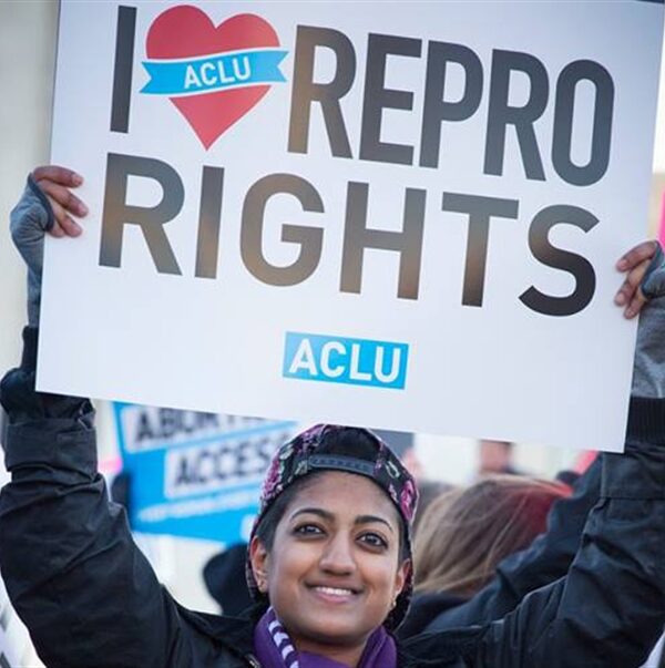 woman holding a sign reading I heart repro rights