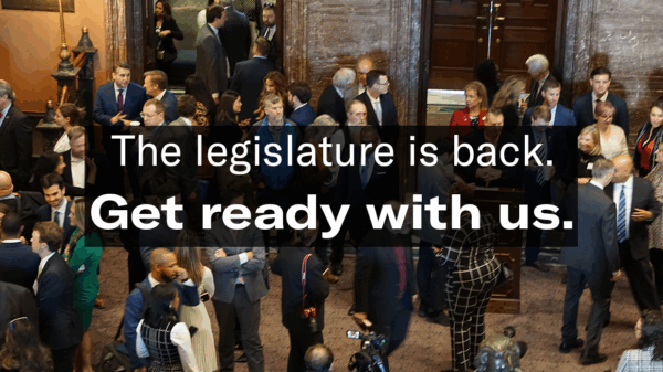 "The legislature is back. Get ready with us." Text is overlaid on an aerial-view photo of people milling around in the State House lobby.