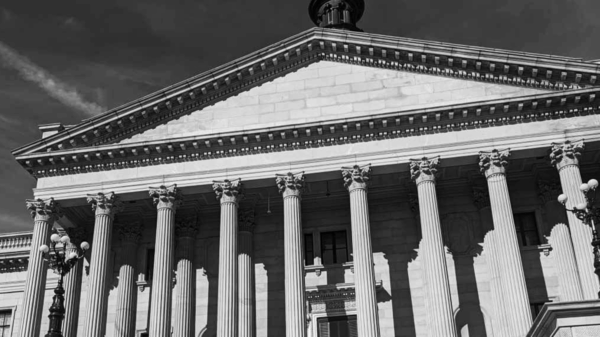 Grayscale photo of people gathered on the State House steps