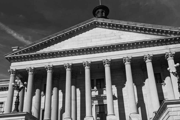 Grayscale photo of people gathered on the State House steps