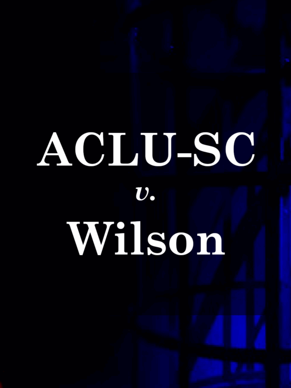 "ACLU-SC v. Wilson." White text on a dark background with shadows of a cage cast by blue and red light.