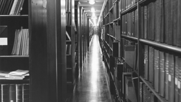 Black and white photo rows of books in a library