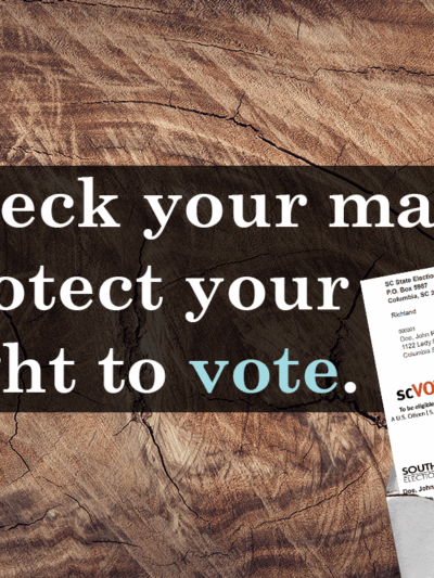 "Check your mail. Protect your right to vote." An open envelope with a Voter Registration Confirmation Card inside. Background is a wood countertop.