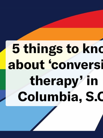 "5 things to know about 'conversion therapy' in Columbia, S.C." Text overlaid on the official Columbia city flag with a pride rainbow color theme.