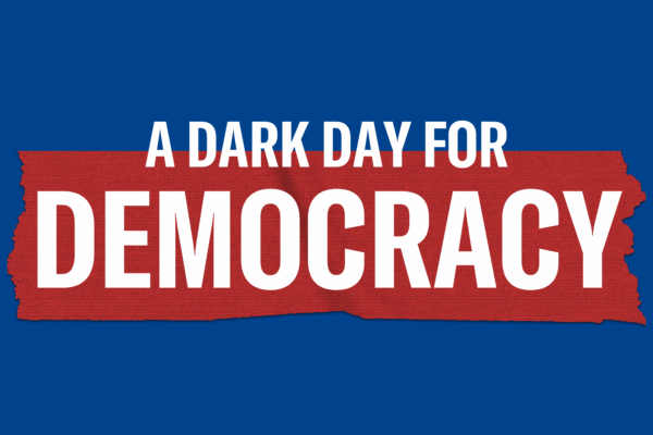 "A dark day for democracy" on a red banner over a blue background
