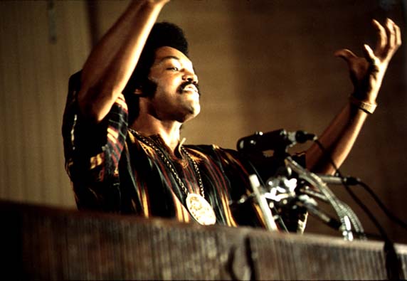 Jackson speaks on a radio broadcast from the headquarters of Operation PUSH (People United to Save Humanity) at its annual convention. July 1973, photograph by John H. White