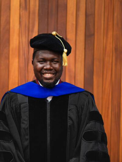 Dr. Matthew Ariwoola in a cap and gown