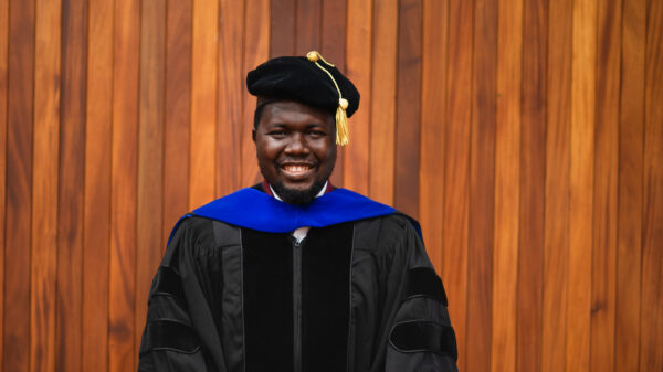 Dr. Matthew Ariwoola in a cap and gown