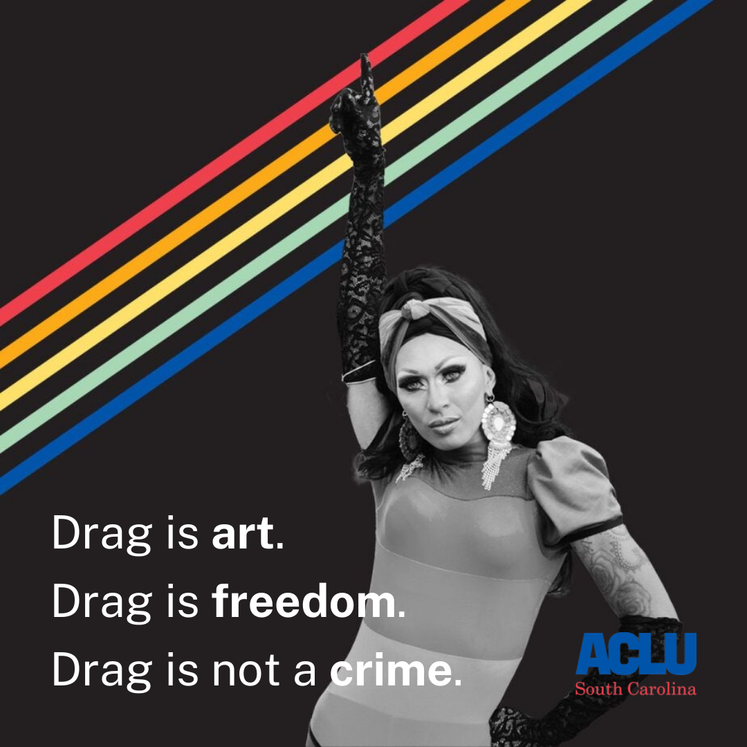 A black-and-white photo of a drag queen pointing skyward over a black background with rainbow stripes. The text reads: "Drag is art. Drag is freedom. Drag is not a crime."