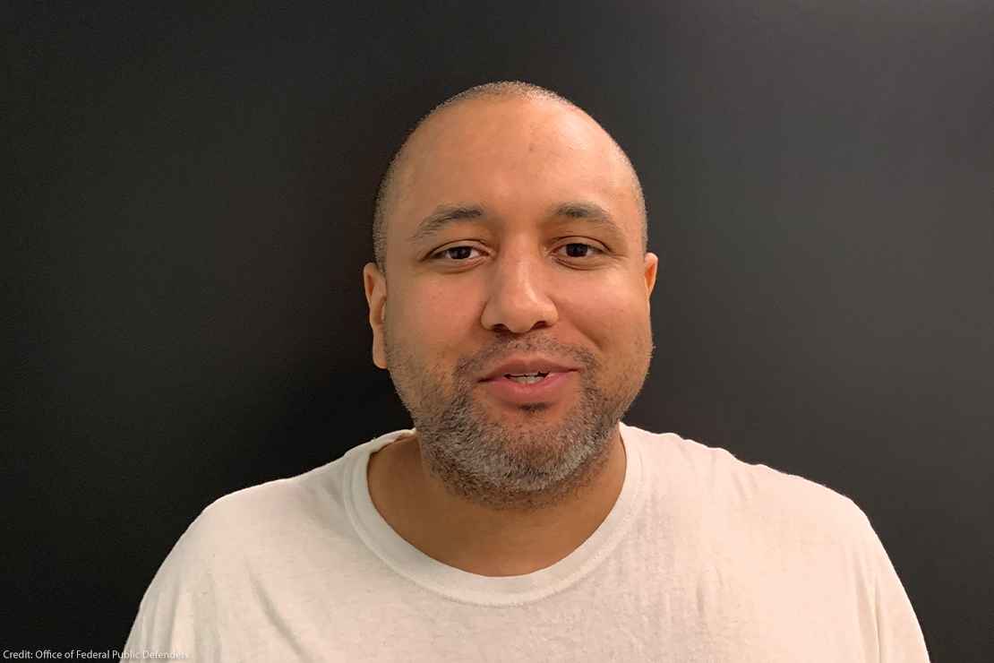 Headshot photo of Mikal Mahdi as an adult in a white T-shirt