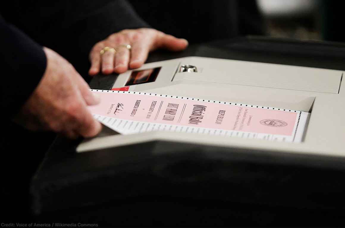 A ballot is entered into a machine at a polling site