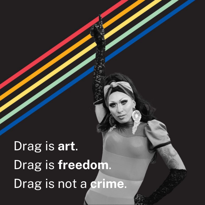 A black-and-white photo of a drag queen pointing skyward over a black background with rainbow stripes. The text reads: "Drag is art. Drag is freedom. Drag is not a crime."