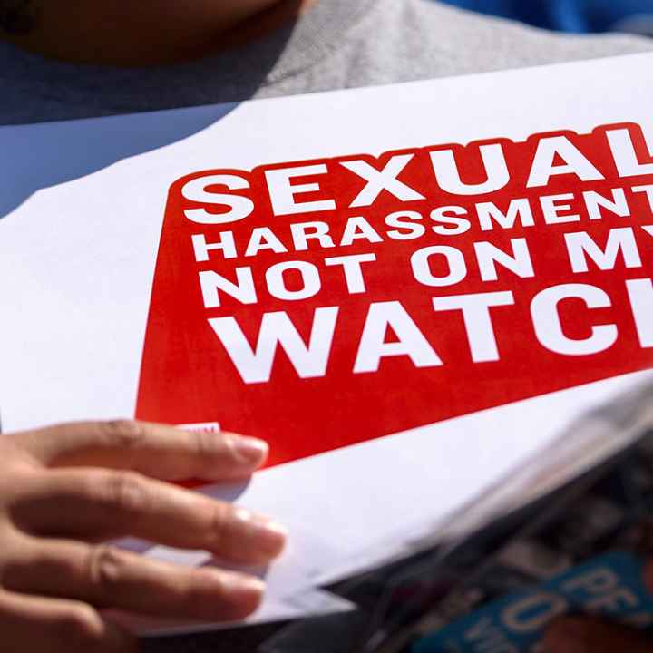 Protester holding sign stating "Sexual Harassment: Not on my Watch